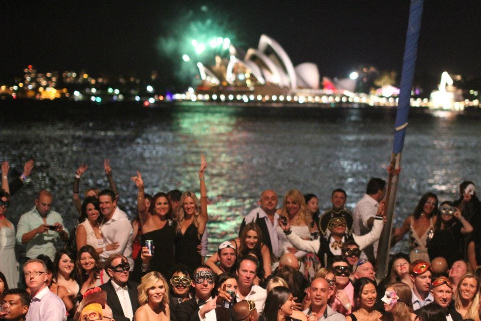 Guests celebrating on Sydney Harbour with Opera House backdrop